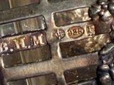 a close up picture of a metal cross with a plaque on it