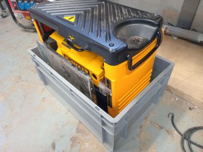 a yellow and black box with a tool in it