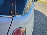 a person sitting in the passenger seat of a small car