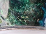 a close up of a glass vase with a green and blue design