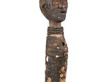 an old wooden statue of a man with a head on a black base