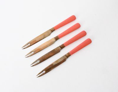 a set of four wooden handled crochet hooks with red handles