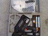 a box with a stapler, stapler, stapler, and other items in it