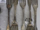 several forks and spoons are sitting on a table with a price tag