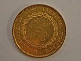 a close up of a gold coin on a white surface