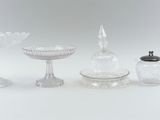 five different glass objects sitting on a white surface