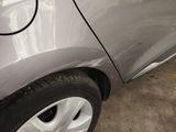 a car that has been dented and is parked in a garage