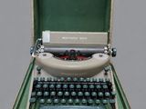 an old typewriter sitting in a case on a table