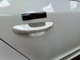 a close up of a car door handle with a sticker on it