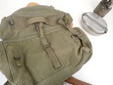 a backpack sitting on top of a table next to a knife