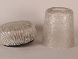 two glass vases sitting next to each other on a table