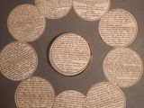 several coins are arranged in a circle on top of a table