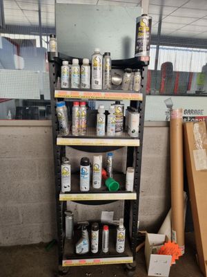 de nombreux pots de peinture posés sur une étagère dans une pièce