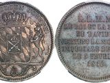 an old silver coin with a coat of arms and a crown on it