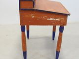 a small wooden desk with a drawer on top of it