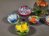 a lot of glass marbles that are sitting on a table