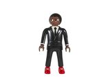 un gros plan sur une figurine représentant un homme en costume-cravate