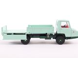 a green toy truck with a bed on the back of it