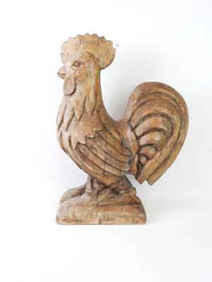 a wooden statue of a rooster on a white background