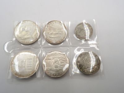 six types de pièces différents, dans des sachets en plastique, posés sur une table