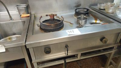 a stove top with pots and pans on it in a kitchen