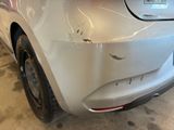 a car that has been dented and is in the garage