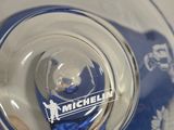 a person holding a glass with a blue bear in it