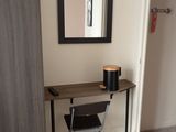 a desk with a mirror and a chair in a room