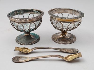 deux plats en argent et une cuillère posés sur une table