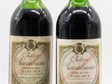 two bottles of wine sitting next to each other on a white surface