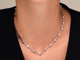a woman wearing a necklace with a cross on it
