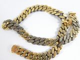 a close up of a gold and silver chain bracelet on a white surface