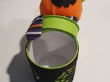 a small orange toy sitting on top of a cup
