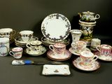 many different types of tea cups and saucers on the table