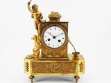 une horloge en or surmontée d'une statue