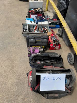 several suitcases are lined up in a row with a sign on them