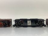 three lego trains are sitting side by side on a white surface