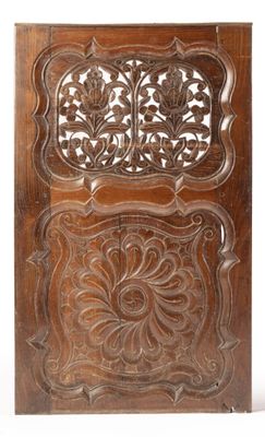 a carved wooden panel with a floral design on it