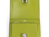 a close up of a green wallet with a coin in it