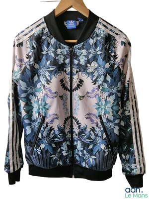 a jacket hanging on a hanger on a white wall
