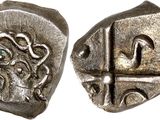a close up of a silver coin with a design on it