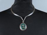 collier en argent avec un pendentif vert autour du cou d'un mannequin