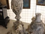 two vases that are sitting on a table in a room