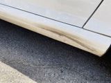 a close up of a car ' s door handle on the side of the road
