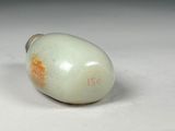a white egg sitting on top of a white table