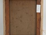 an old picture frame with a tag attached to it on a white wall