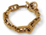 a close up of a gold bracelet on a white background