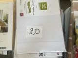 a pile of papers and a pair of scissors sitting on a bed