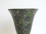 a green vase that is sitting on a table