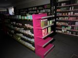 a pink shelving in the middle of a store aisle